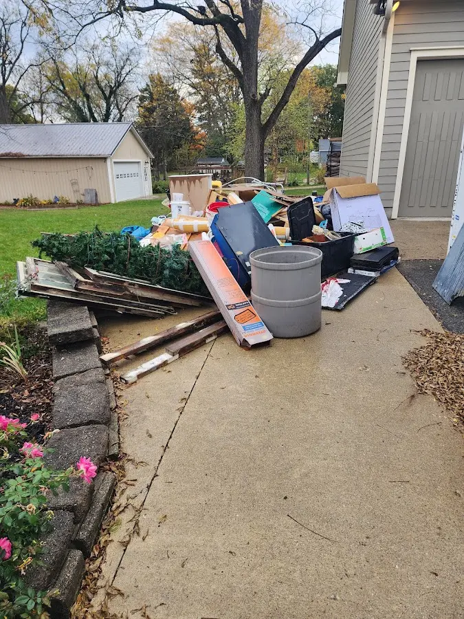 Dumpster being loaded with debris for Commercial Dumpster Rental in North St. Paul
